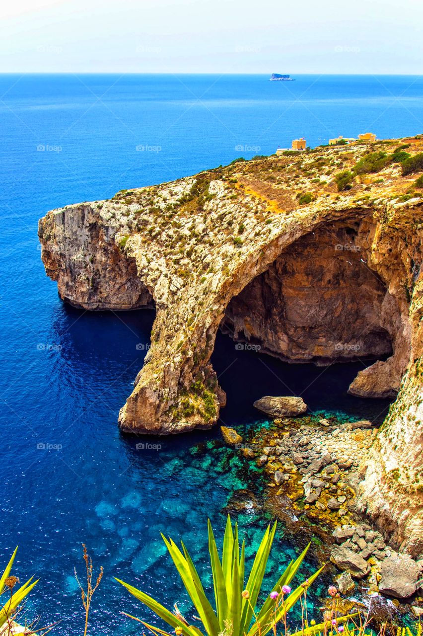 The natural rock formations at the Blue Grotto, in Malta.