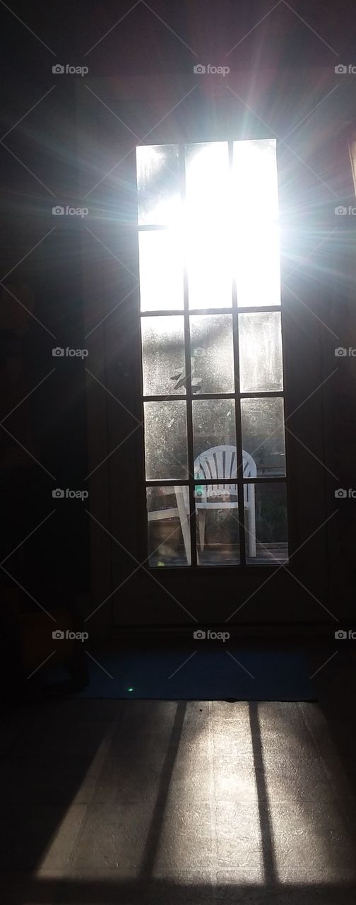 sunset through the glass door casting light and shadows throughout the room