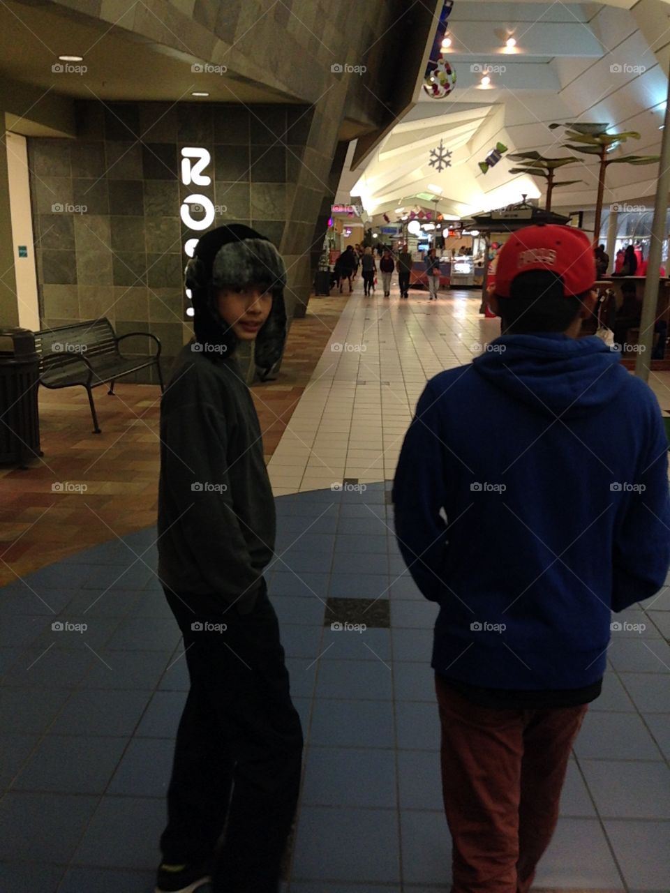 Two boys walking in mall