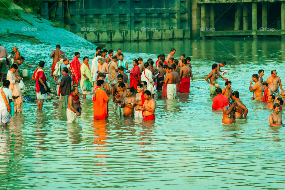 HARIDWAR, INDIA - JANUARY 14, 2016: Devotees taking holy dip at Har Ki Pauri on river Ganga on the first bath of Ardh Kumbh fair. People took a dip in holy Ganges on the occasion of Makar Sankranti