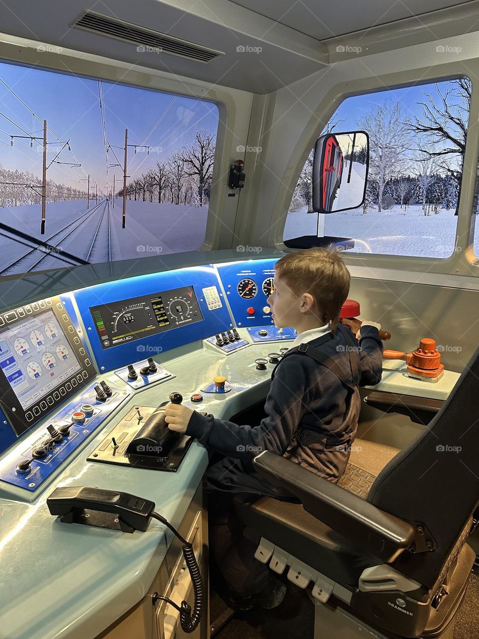 Boy in the train near the windows 