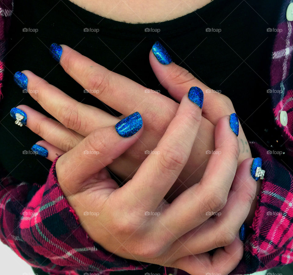Young woman's sparkling blue nails