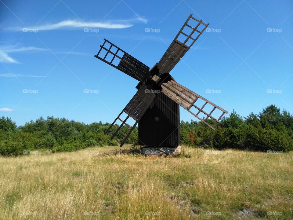 Old windmill on grassy field