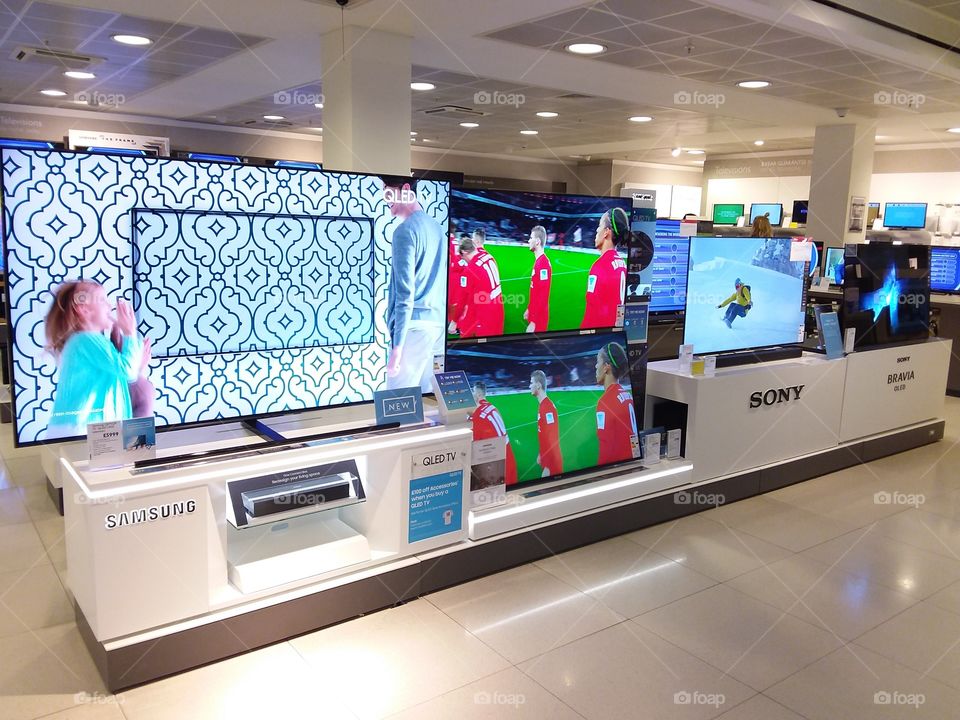 Samsung 75" QLED ambient mode 4K Ultra High Definition TV displaying one connect box and wall mounted televisions at Peter Jones department store Sloane square Chelsea Kings road London