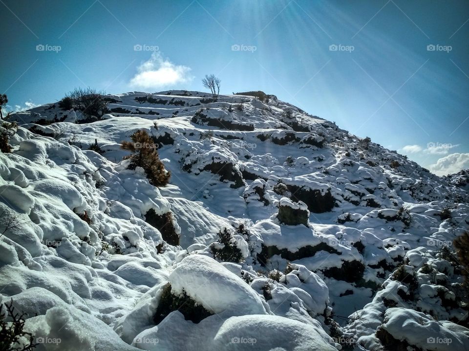 sunlight falling on the snowy mountain.