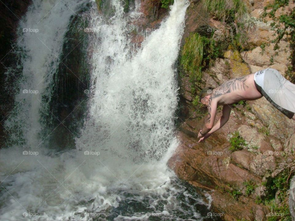 Jumping by the waterfall.