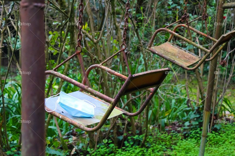 Rusty swing with face mask
