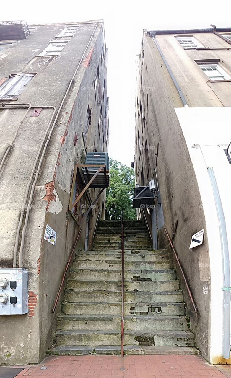 steep stairs up a narrow gap between historic buildings in Savannah, Georgia