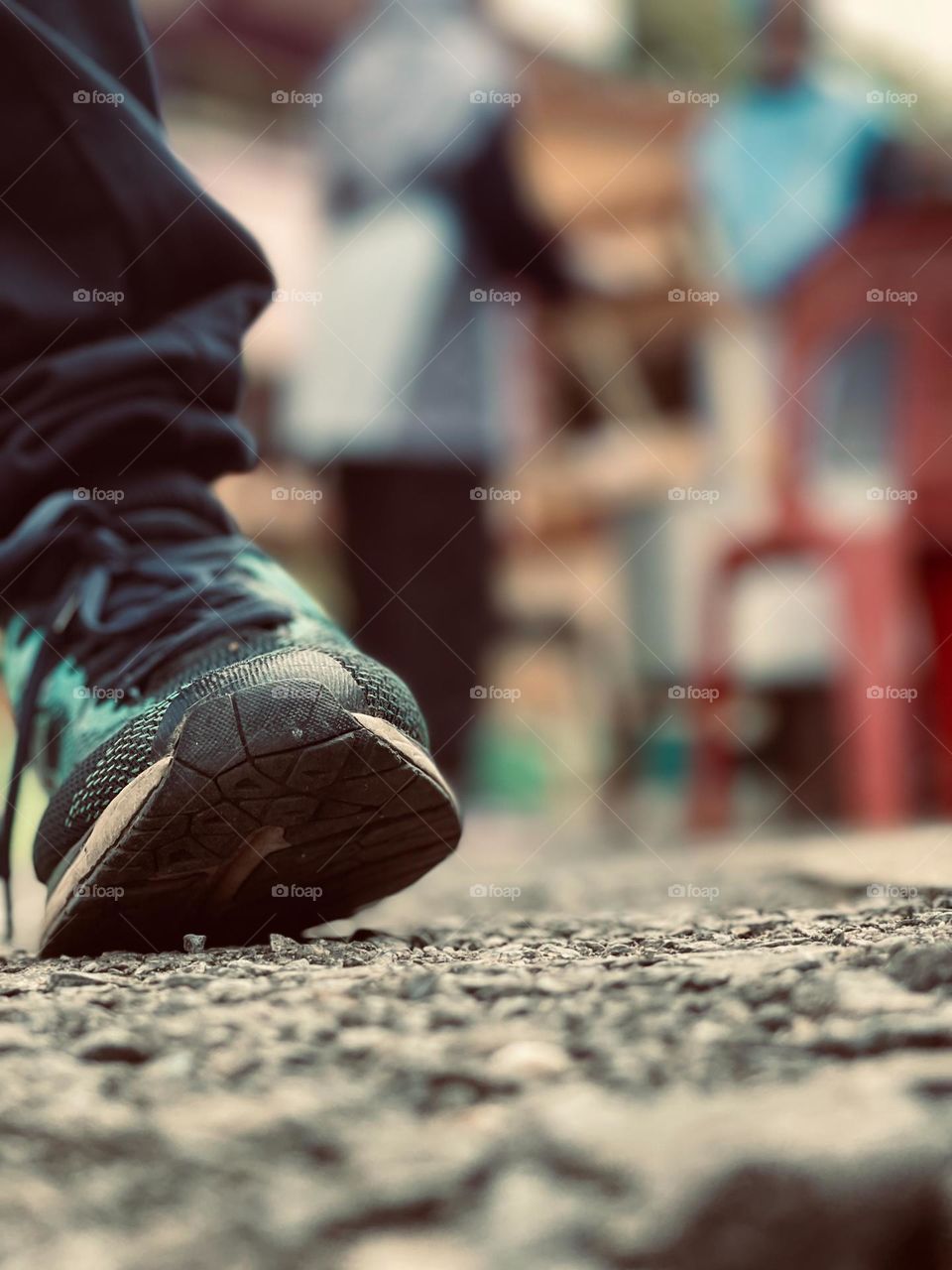 Sport shoes on a walking pavement in close up view.