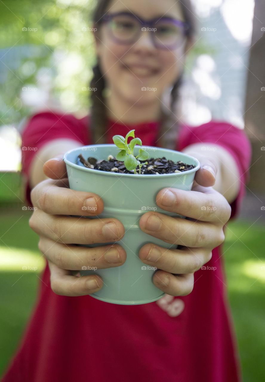 Girl holding a spring plant