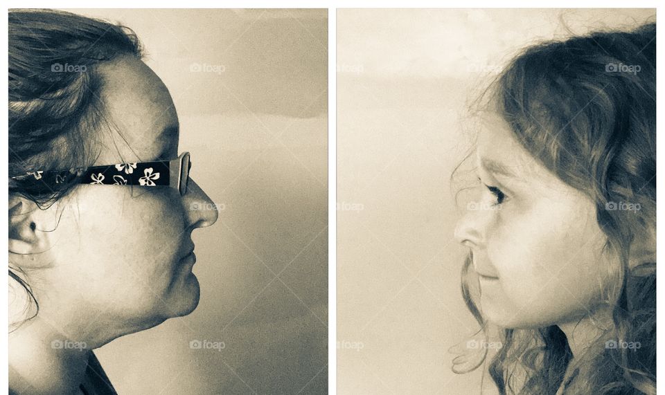 Close-up of a mother and daughter's face in photograph