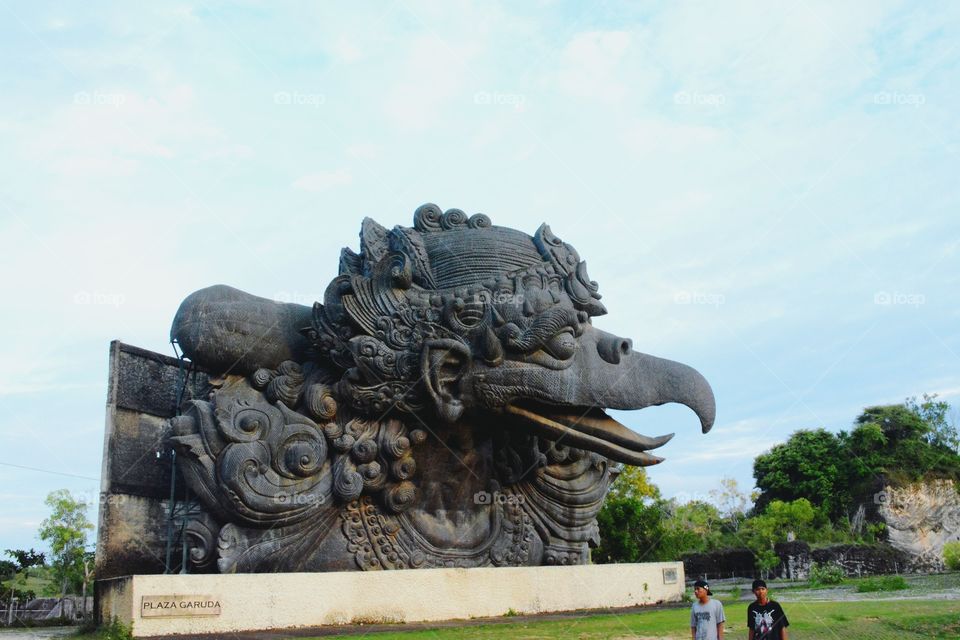 Garuda Wisnu Kencana Cultural Park, abbreviated GWK, is a tourist park in the southern part of the island of Bali. This tourist park is located on the headland of Nusa Dua, Badung regency, about 40 kilometers south of Denpasar, the capital of Bali province. In the area of ​​this cultural park, planned to be established a landmark or mascot of Bali, which is a giant statue of Lord Vishnu who was riding a ride, Garuda, as high as 120 meters. Garuda Wisnu Kencana Cultural Park is located at an altitude of 146 meters above ground level or 263 meters above the sea level.

In the area there is also a Statue of Garuda which is directly behind the Plaza Wisnu is Garuda Plaza where the statue as high as 18 meters Garuda placed temporarily. At this moment, Garuda Plaza becomes the focal point of a large corridor of carved limestone pillars covering over 4000 square meters of open space ie Lotus Pond. The colossal limestone columns and monumental sculptures of Lotus Pond Garuda make a very exotic space. With a space capacity capable of accommodating up to 7000 people, Lotus Pond has earned a good reputation as the perfect venue for holding major events and international events.

There is also a statue of Vishnu's hand which is part of the statue of Lord Vishnu. This is one step closer to completing the complete Garuda Wisnu Kencana statue. This work is placed temporarily in the area of ​​Tirta Agung.

Wikipedia.