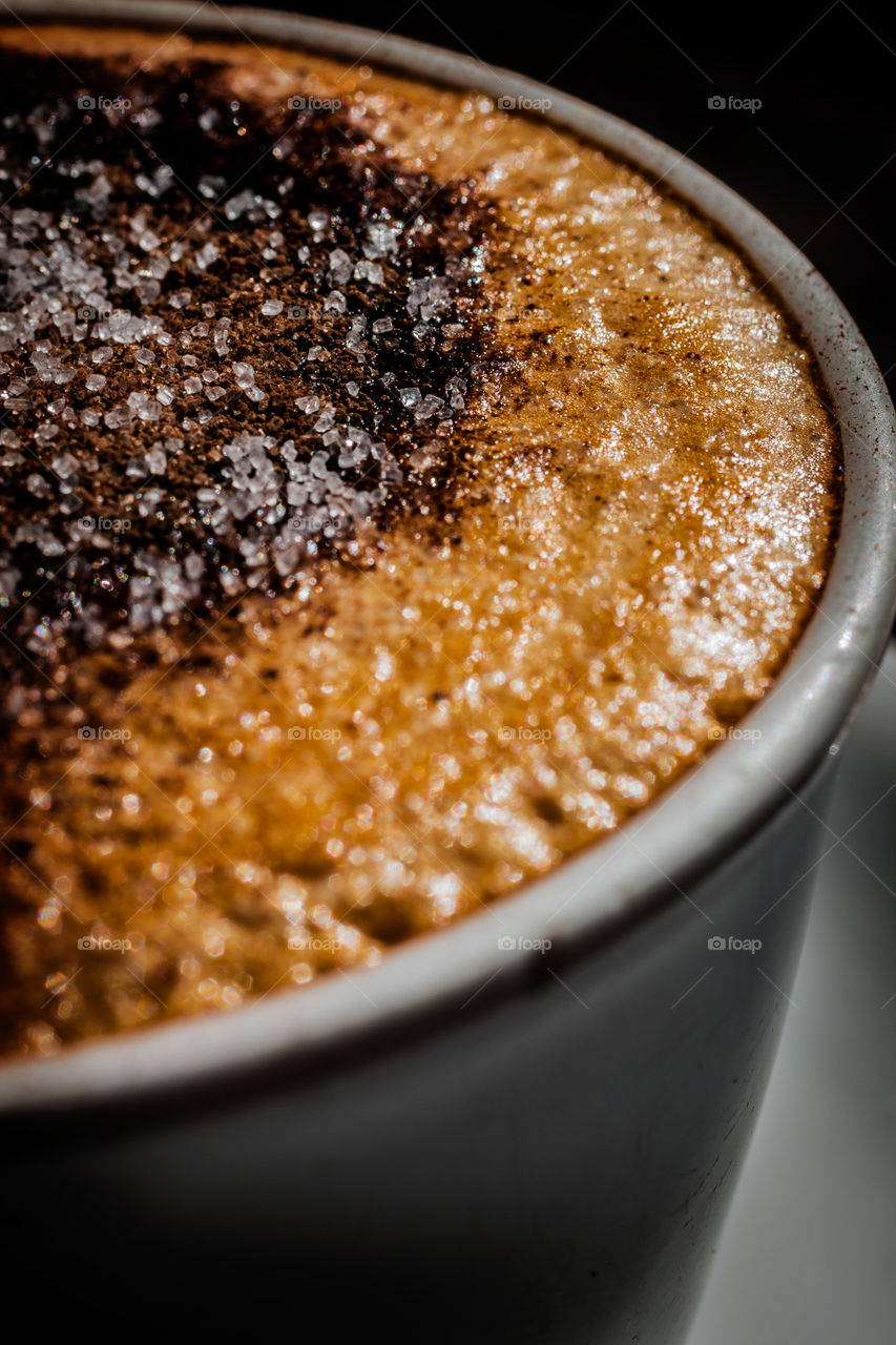 Cappuccino with highly detailed sugar crystals on top.