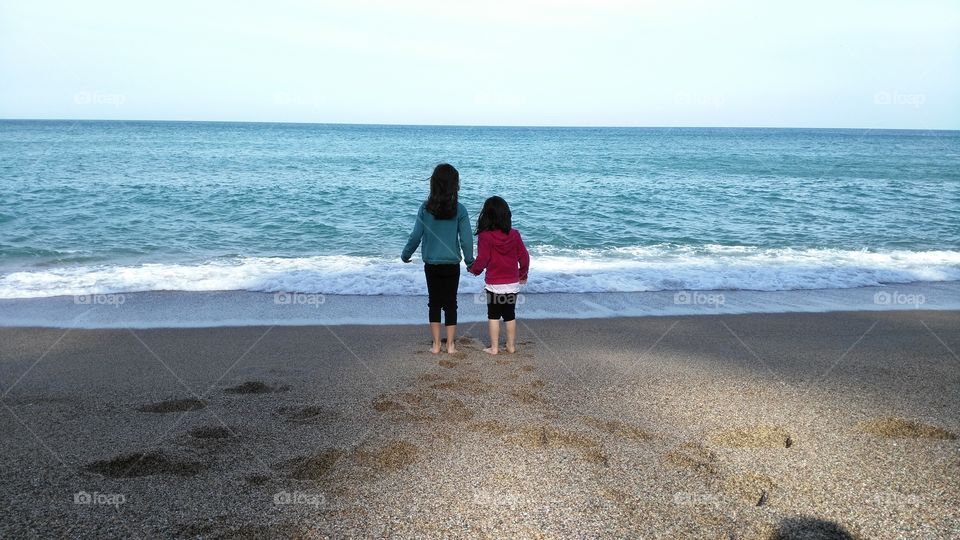 beach girls. two little sisters at the beach