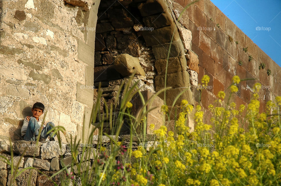 Kid sitting on the fortress