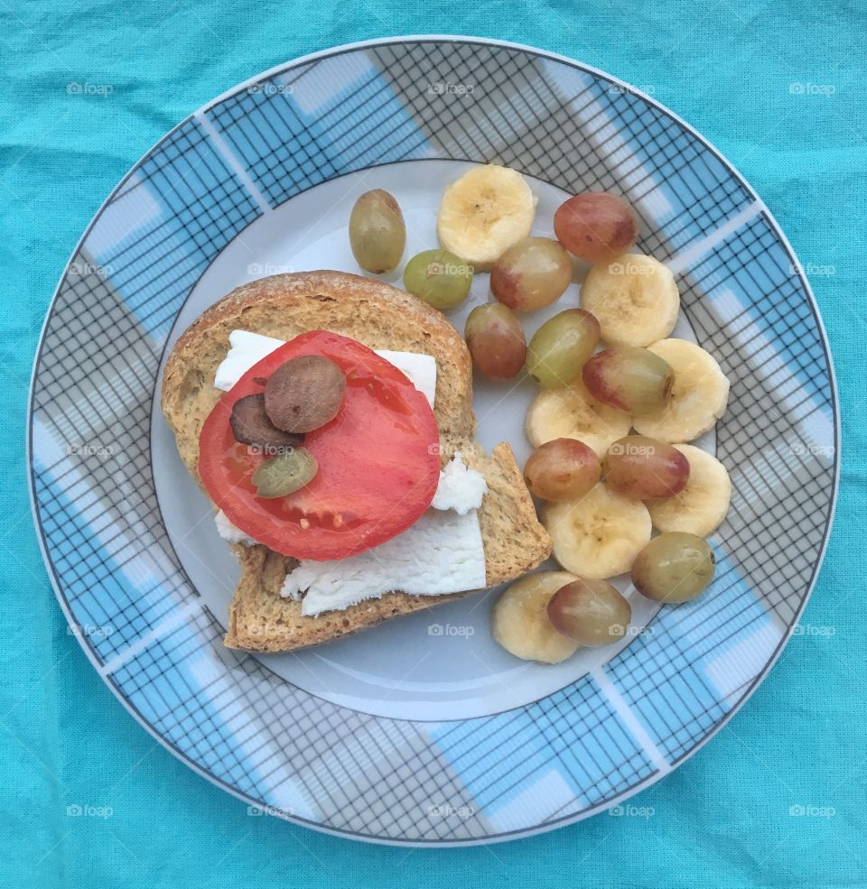 Feta, Tomato, Olives on Crunchy Bread with Bananas and Grapes 