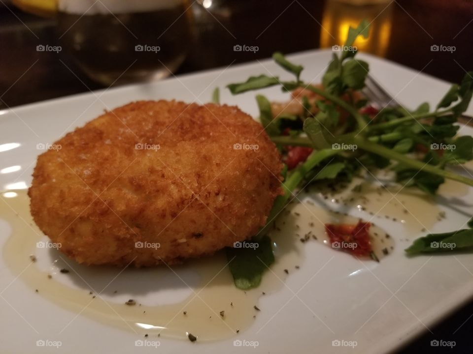 Fried goat cheese with a miniature side of greens. What else should be eaten in Canada?