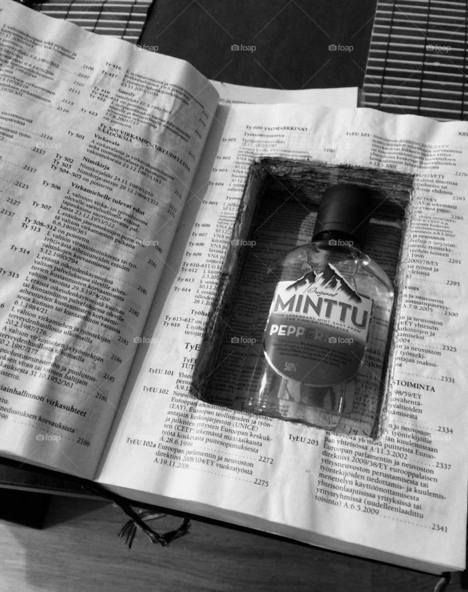 A secret - a Bottle of liquir hidden inside a law book / Black and White