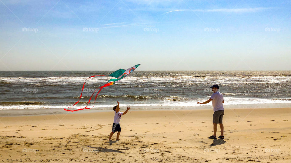 Flying kites on a windy and sunny day at the beach. A little slice of heaven! 