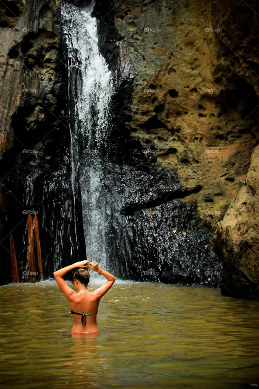 Women are playing a relaxing waterfall in the summer.