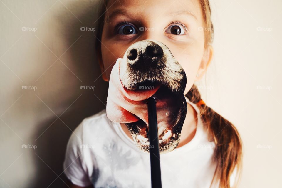 Girl holding dog mask