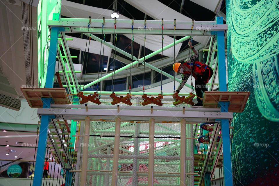 A man is setting up a monkey bar .