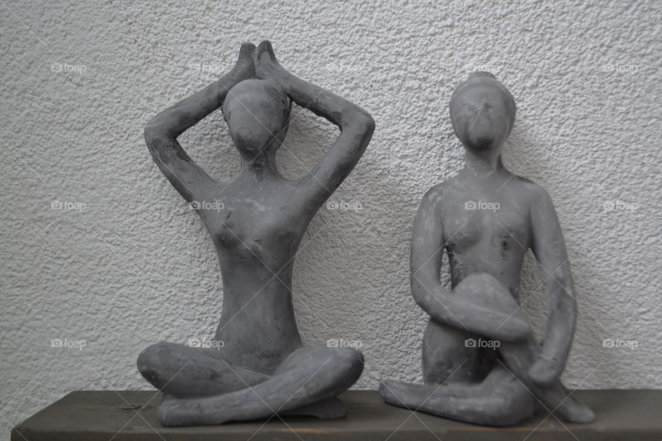 Two yoga ladies. Two litle hand made ladies in yoga sit.