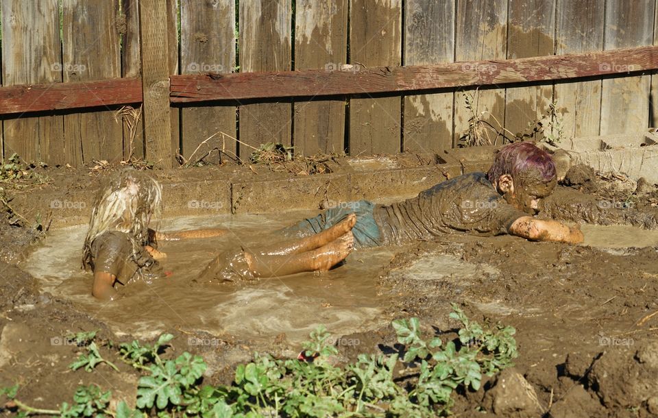 Kids Playing In Mud