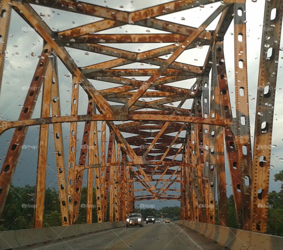 Rusty Storm. Rusty old bridge during storm.