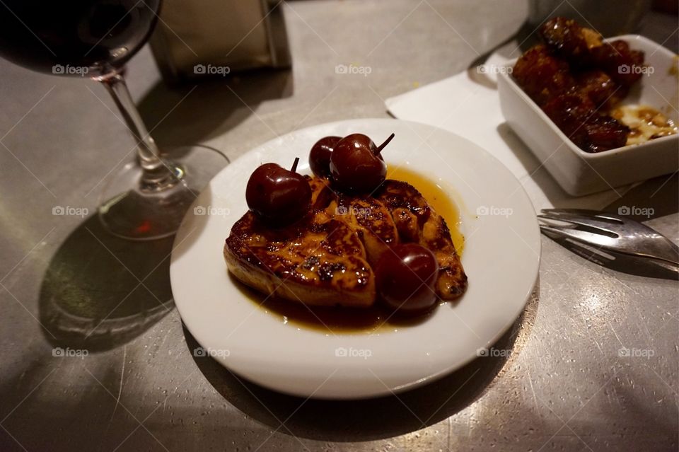 Seared foie gras with wild cherries and a side of caramelized pork belly at L'Avant Comptior, Paris