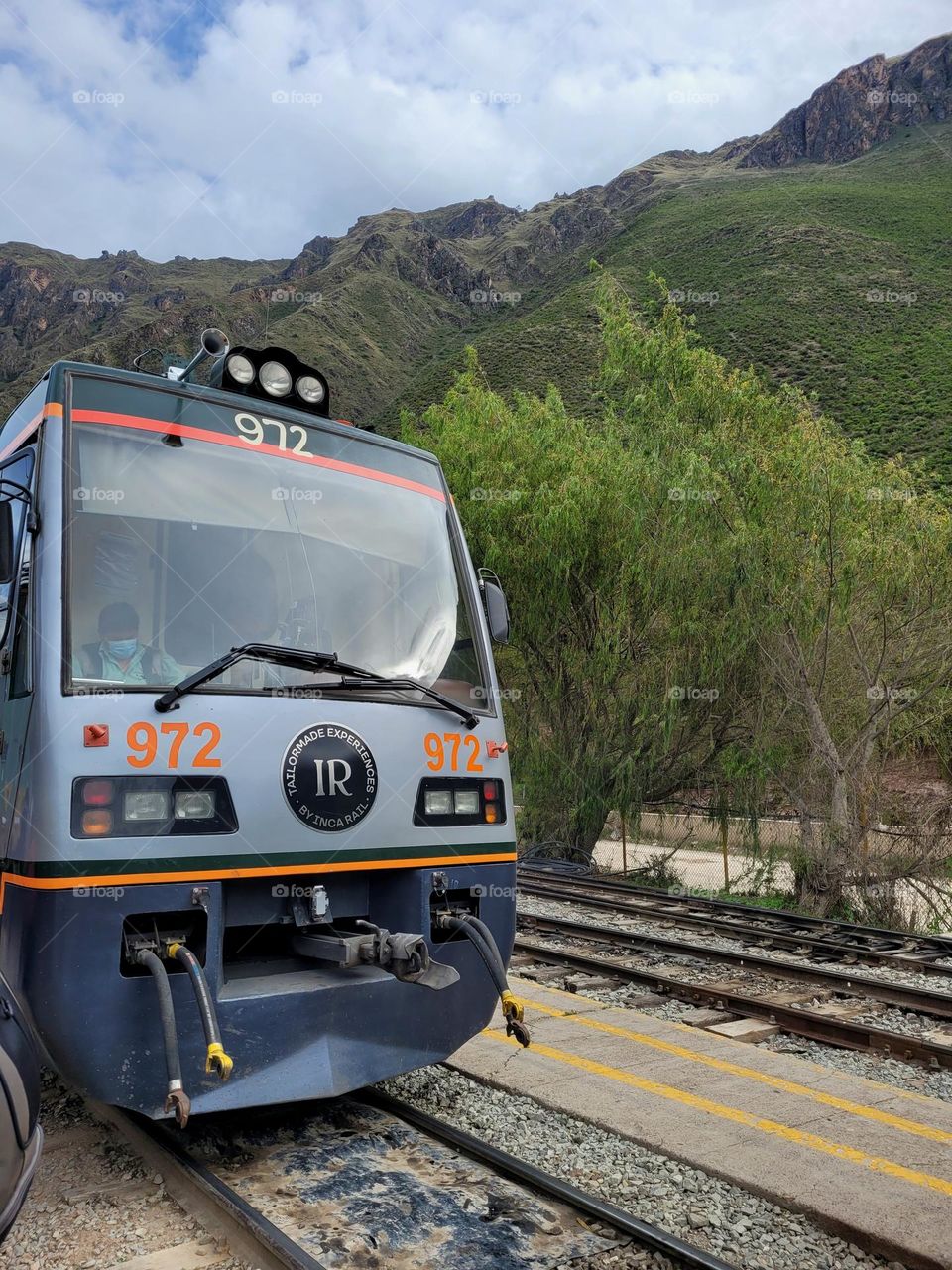 Front window of train on railroad in mountain landscape in the countryside.