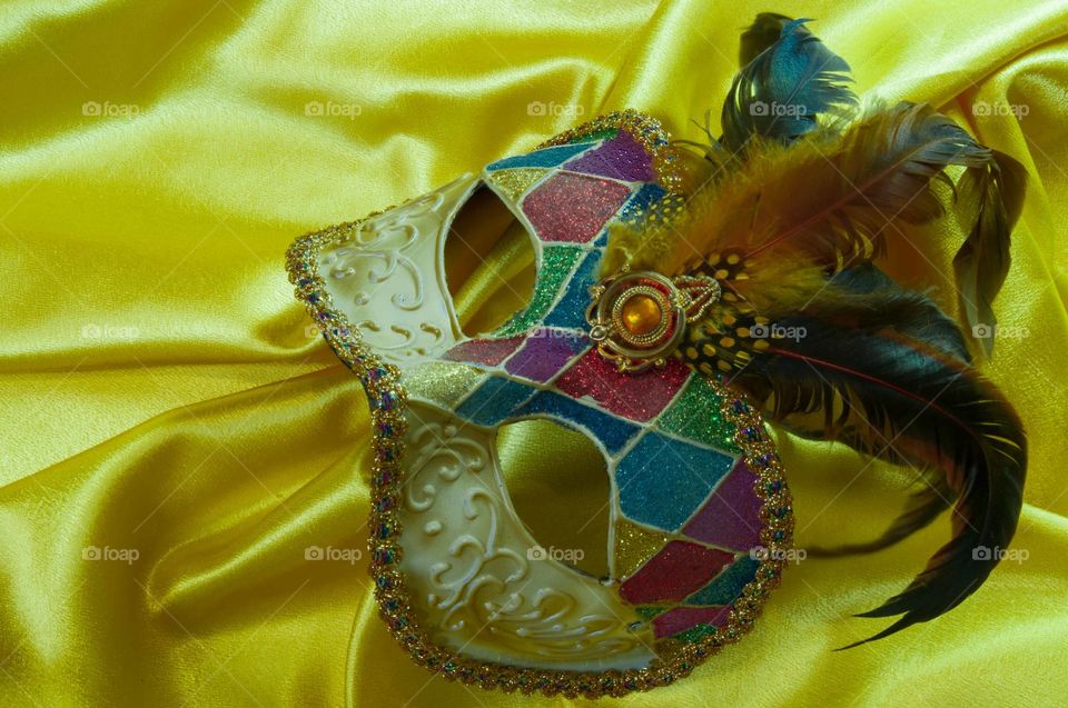 Venetian mask on yellow satin