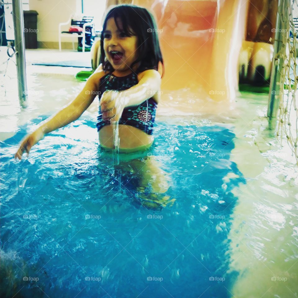 excited little girl going down water slide
laughing
JOY
happiness
splishsplash