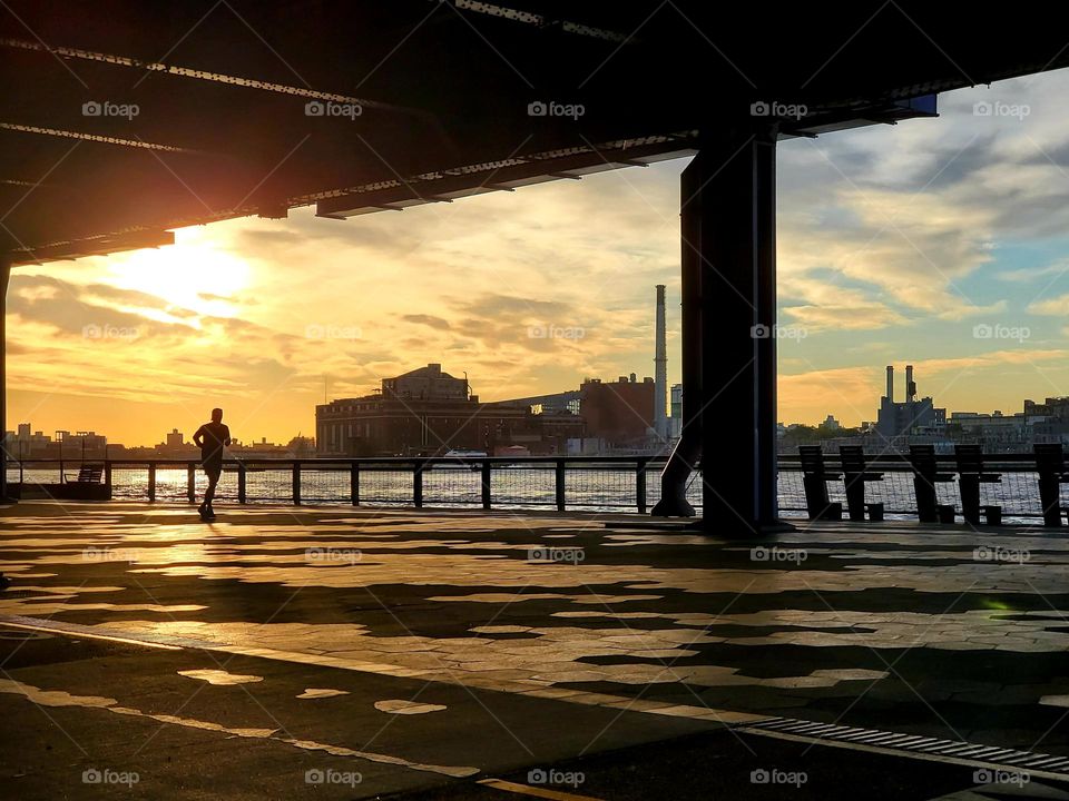 A jogger runs along the waterfront in New York City
