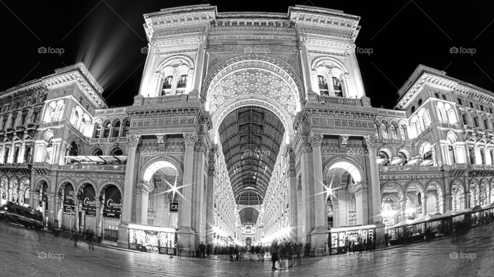 Night in Milan. The magnificent "Galleria Vittorio Emanuele II" with its palaces and shops, view from the cathedral square. black and white version