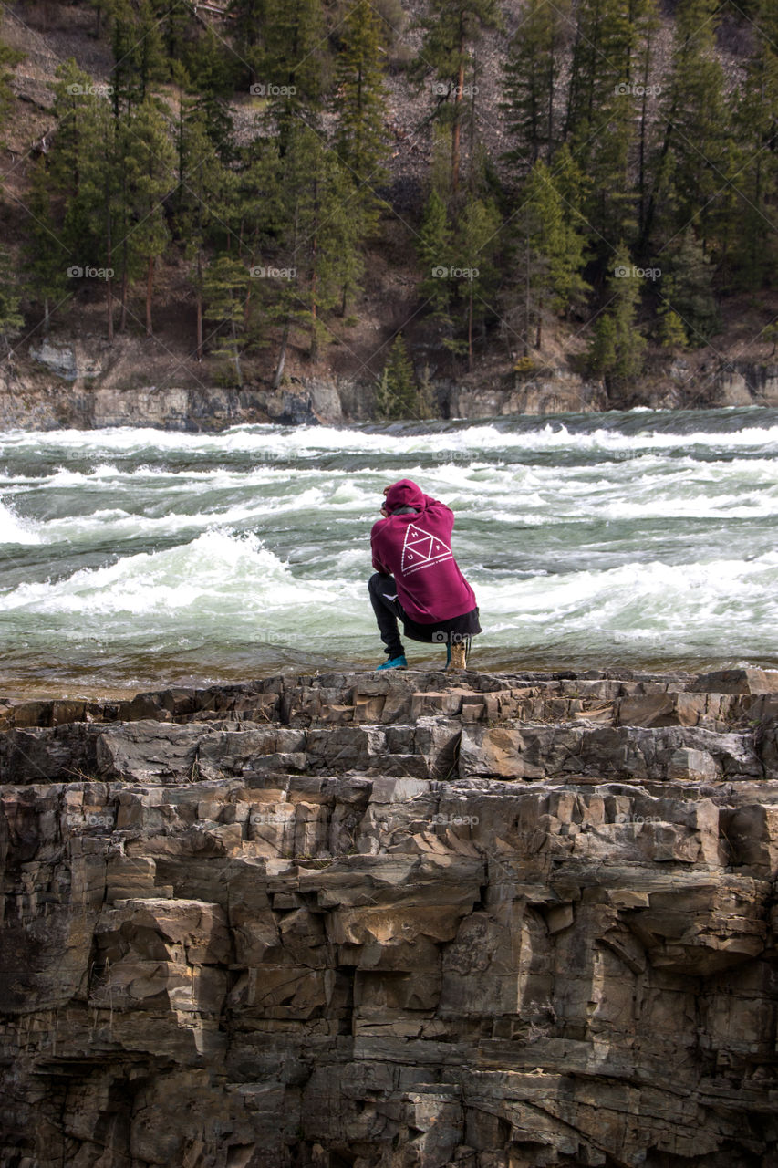 Getting risky on the edge of a waterfall. 