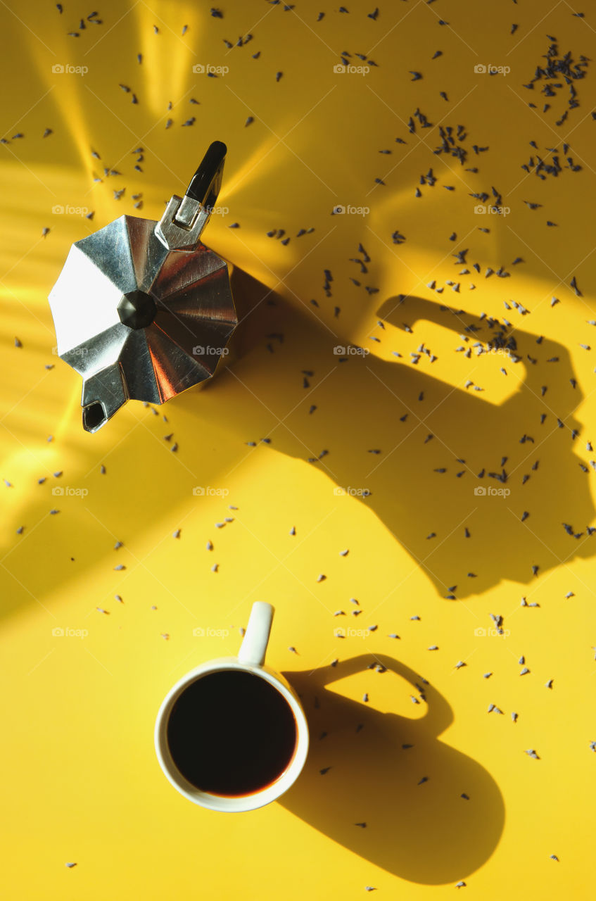 Business working morning with cup of hot coffee, french press, lavender flowers on yellow background close up. Top view, copy space, flat lay, mockup.