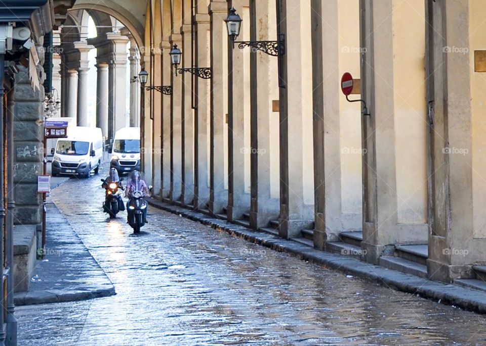 Men Ride Motorcycles on City Road, Florence