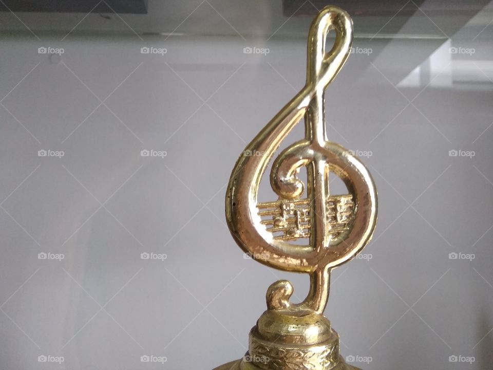 G clef trophy. It's a golden trophy won from a musical contest. G clef is a symbol for music lovers. Everyone who loves music, loves this picture.