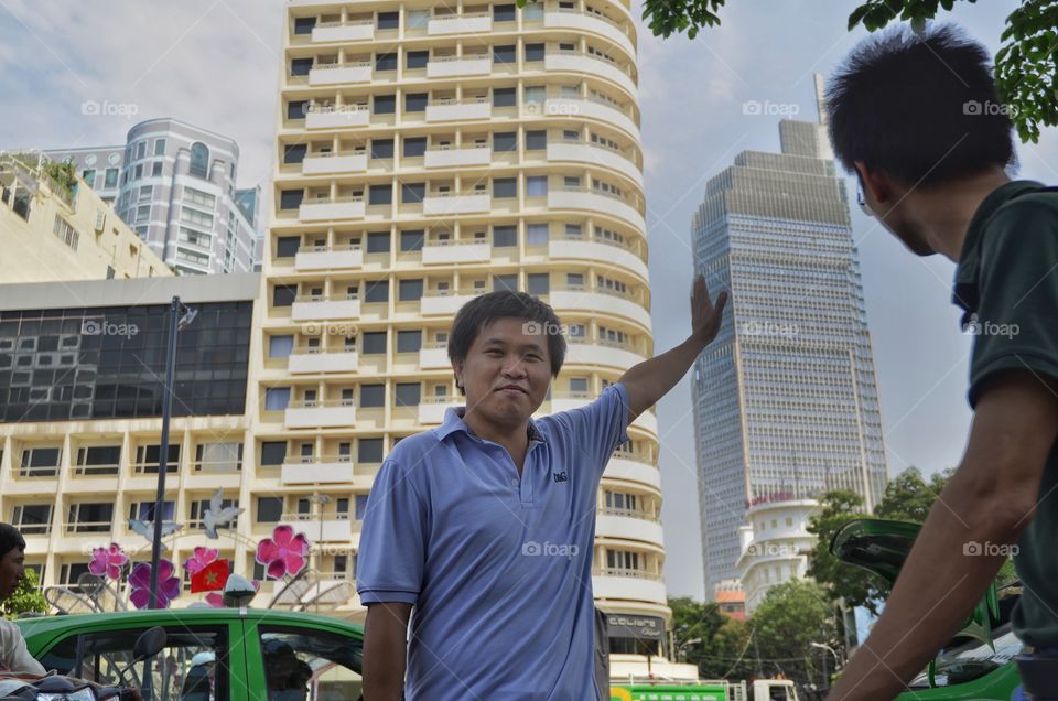 Asian man standing in front of building
