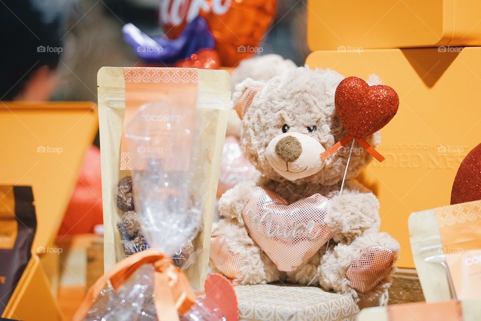 Brisbane, Australia - April 21, 2018 : A cute teddy bear. Presents for Mother's day with a bag of chocolate and teddy bear soft plush from San Churros, the Chocolatier shop. Editorial use only. 