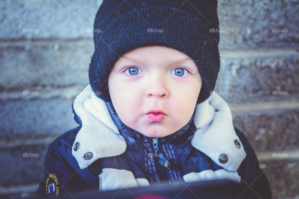 Cute boy in black woolly hat