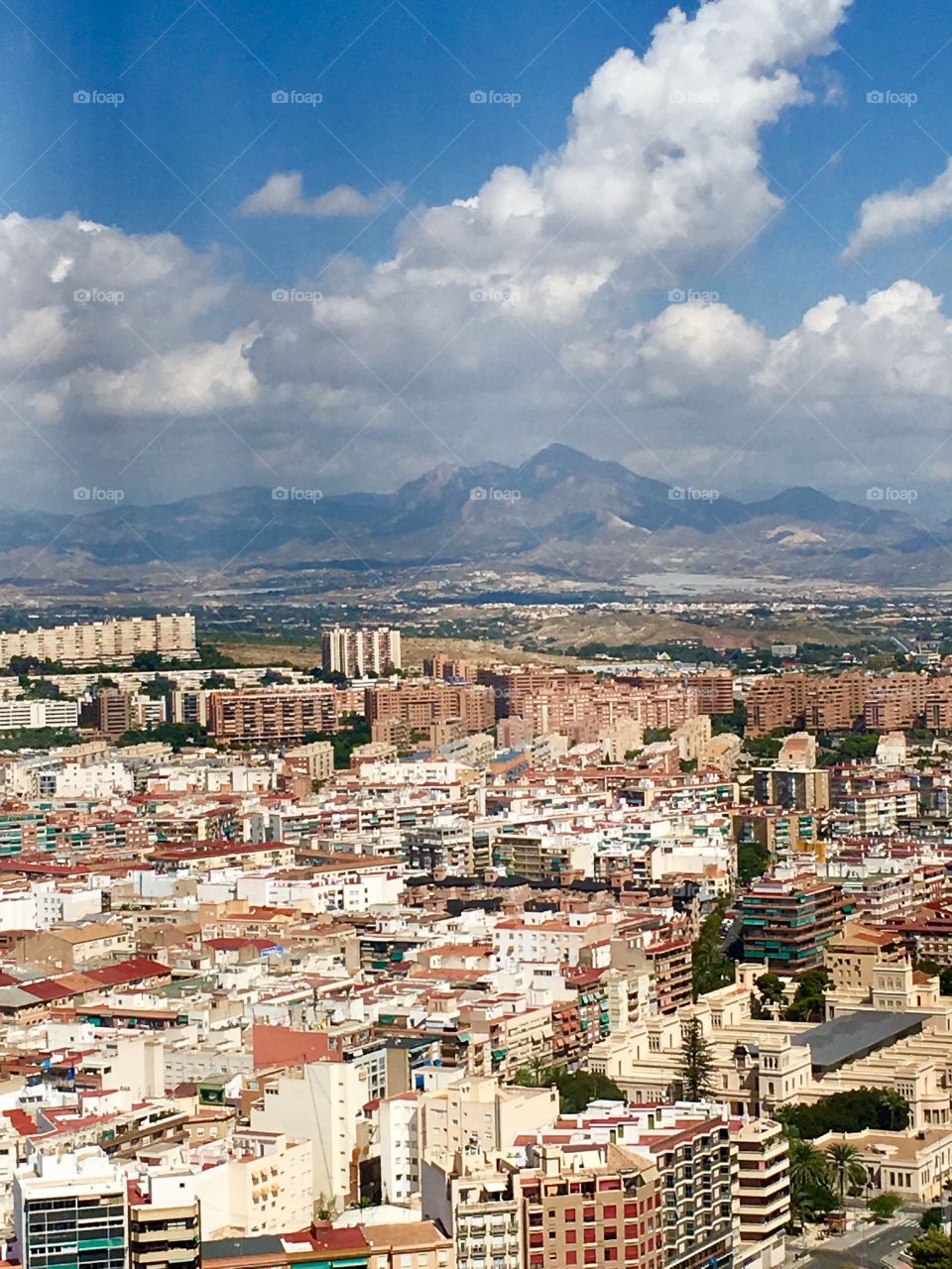 A picture of the city of Alicante, Spain with mountains in the distance. Taken from a high castle 
