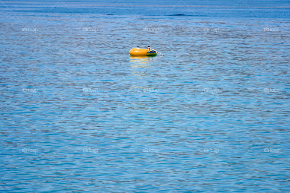 Orange boat's floating on sea surface