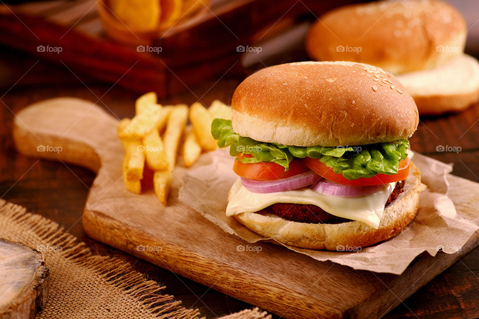 burger sandwich on a wooden platter