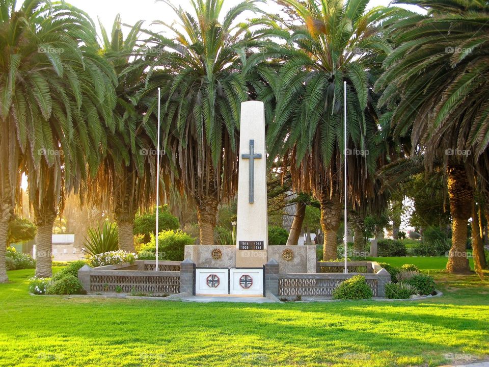 Cross sign and palm trees on the german monument in Swakopmund,
Namibia, South Africa