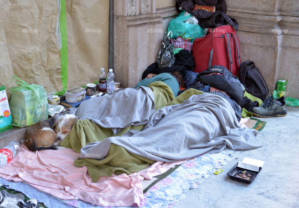 homeless people sleeping on the sidewalk