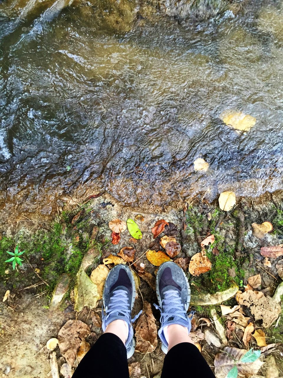 Exploring the mountains of Haiti - crossing a stream to explore a cave. 