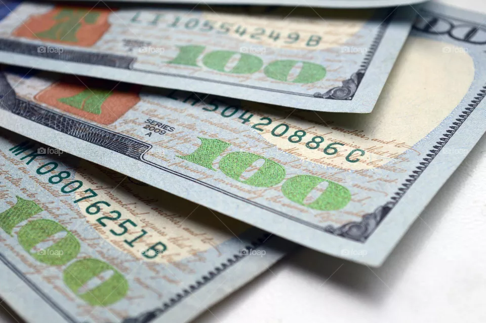 hundred dollar bills are on the table