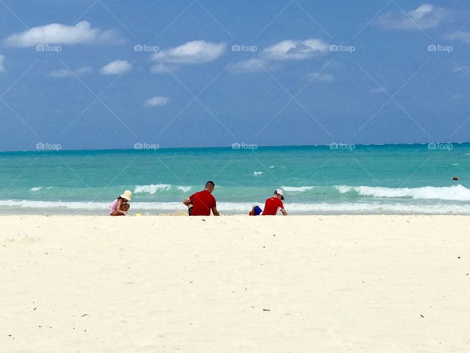 Dad and kids playing on beach in Cuba
